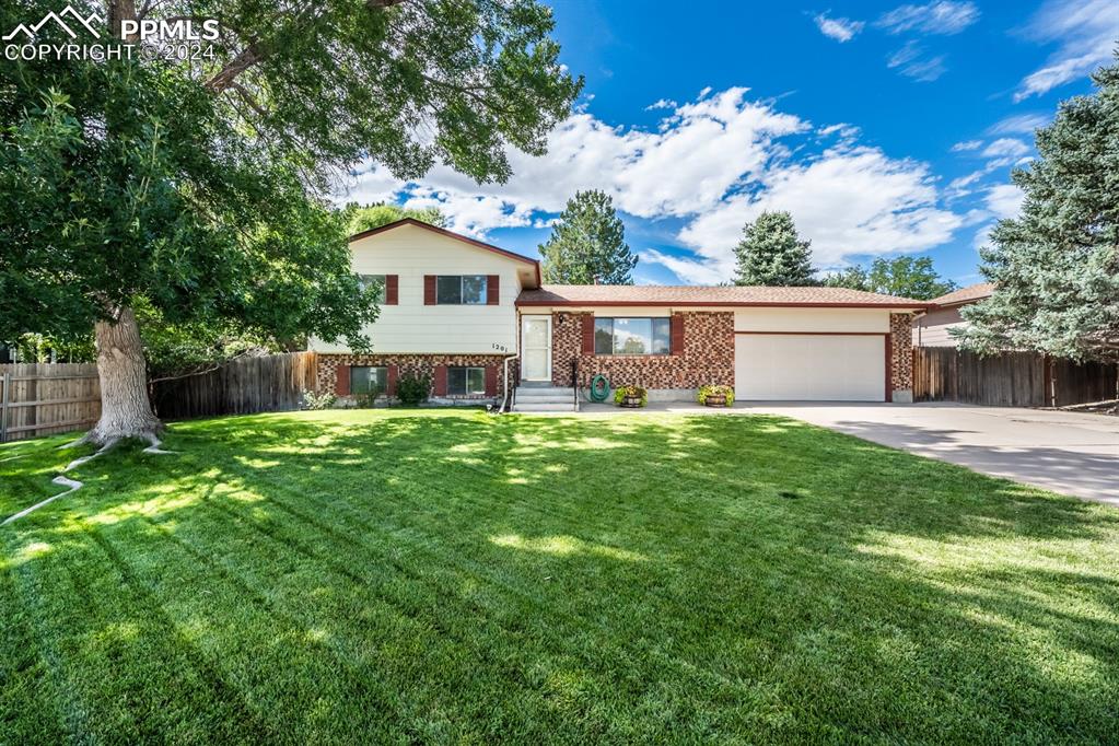 Tri-level home featuring a front lawn