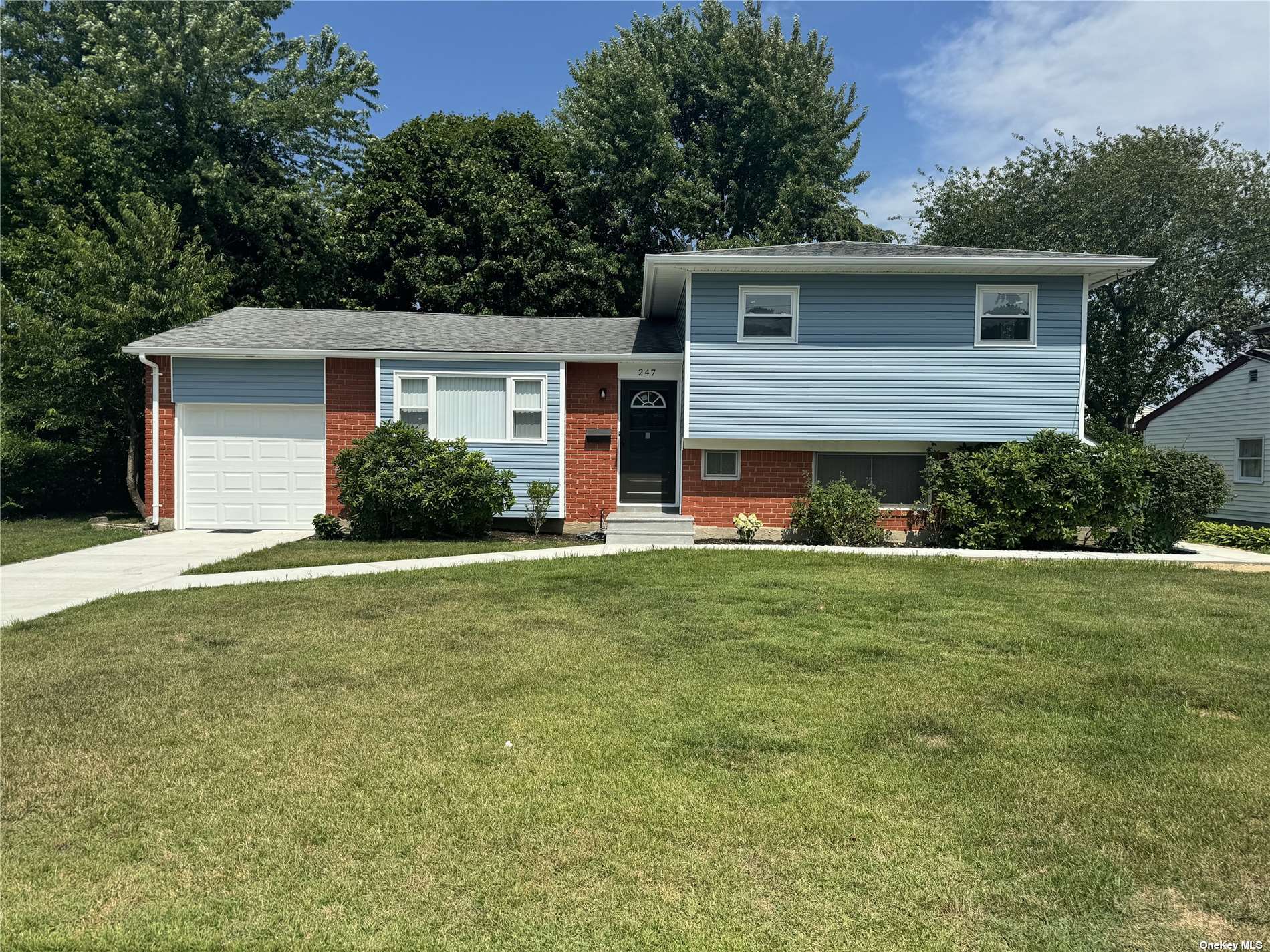 a front view of house with yard and green space