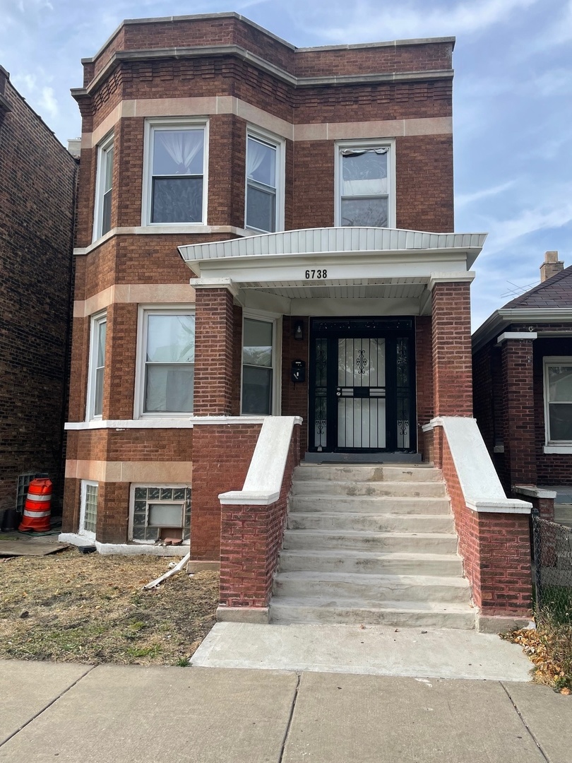 a front view of a house with stairs