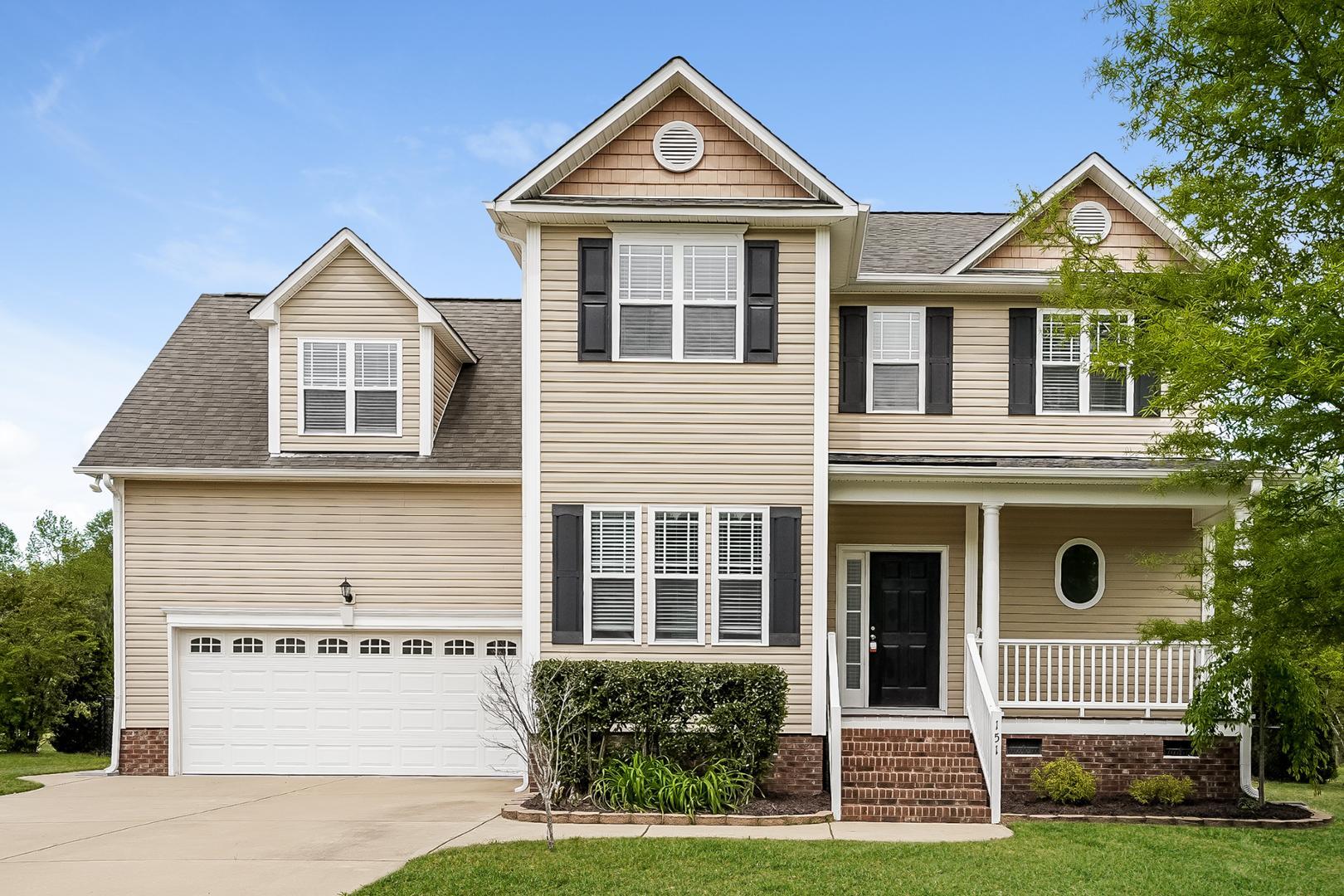 a front view of a house with a yard