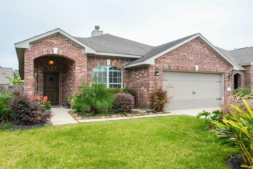 a front view of house with a garden