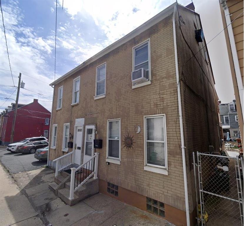 a front view of a house with parking space