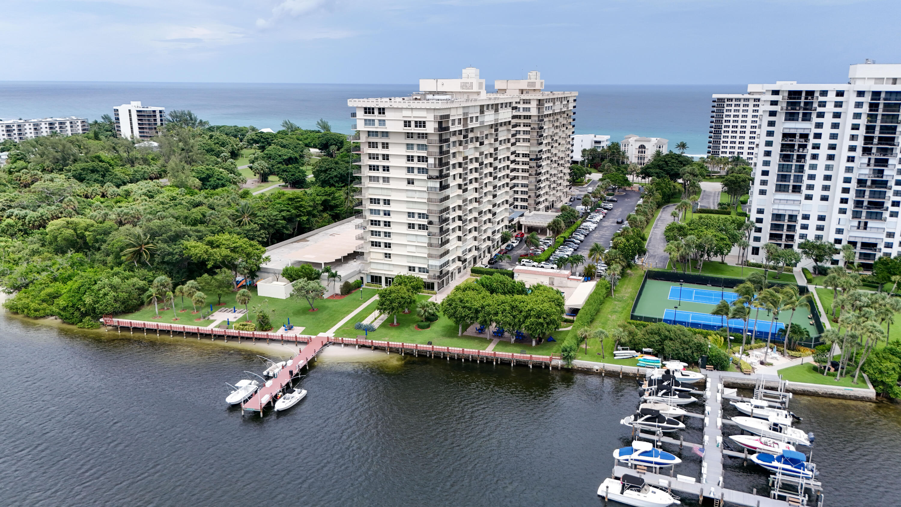 an aerial view of residential houses with outdoor space and lake view