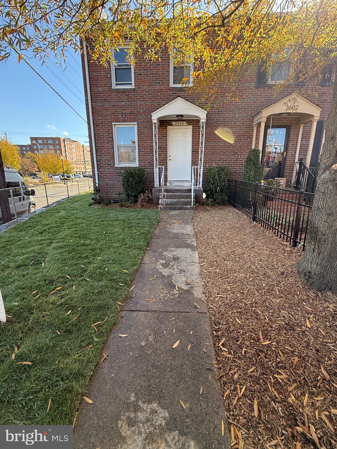 a front view of a house with a yard and potted plants