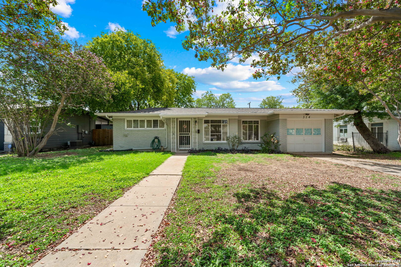 front view of a house with a yard