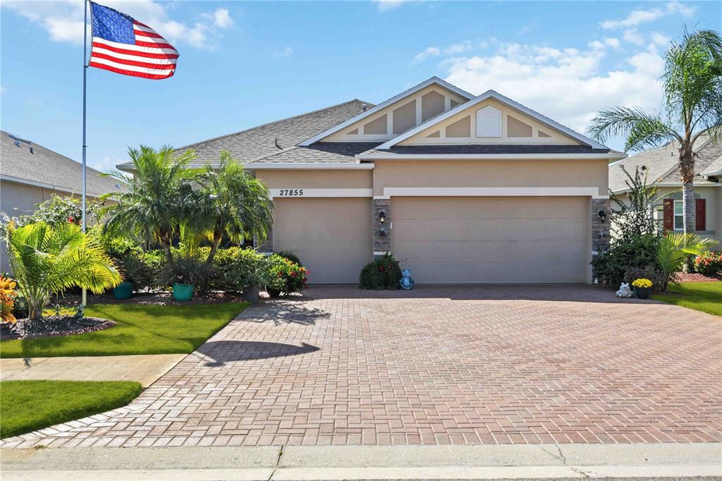 a front view of a house with a yard and garage