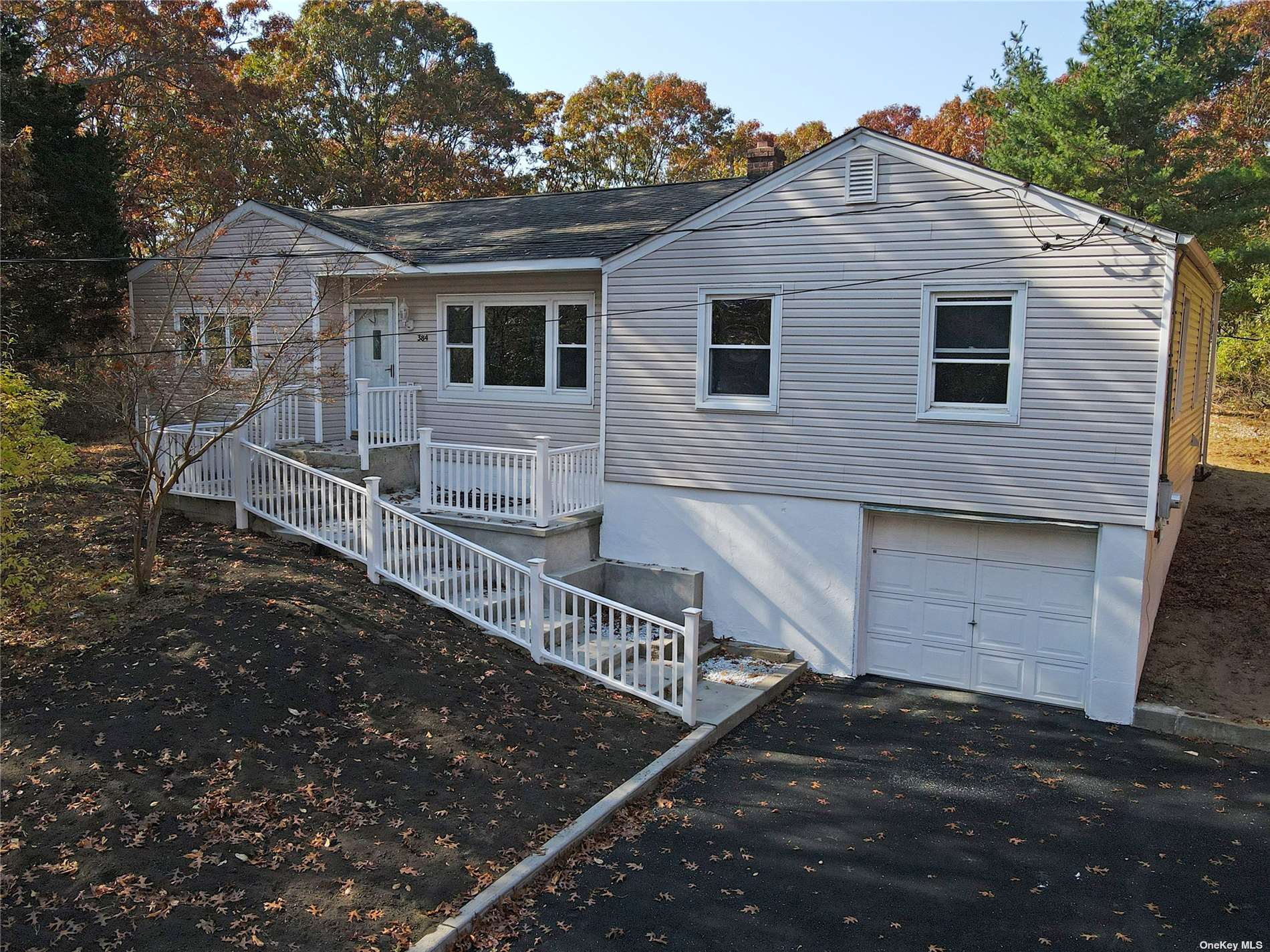 a view of a house with a wooden fence