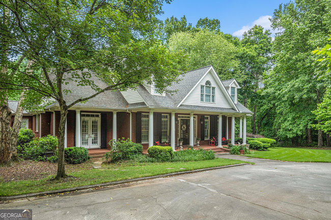 a front view of a house with a garden