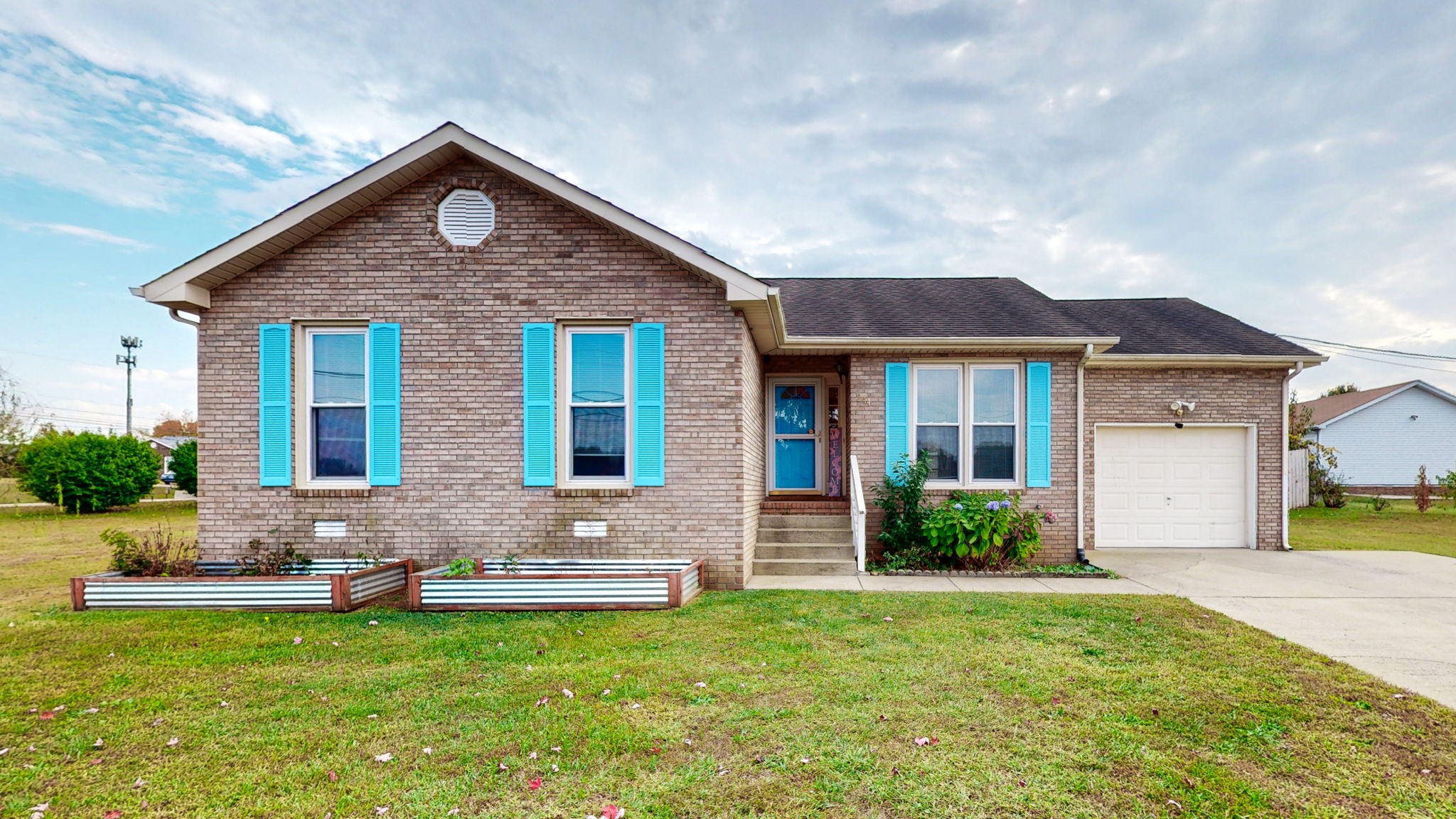 a front view of house with yard and green space