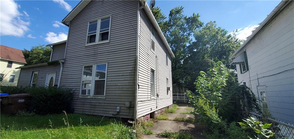 a view of a house with a yard and plants