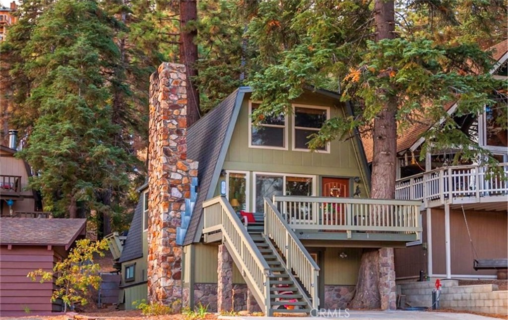 a front view of a house with a tree