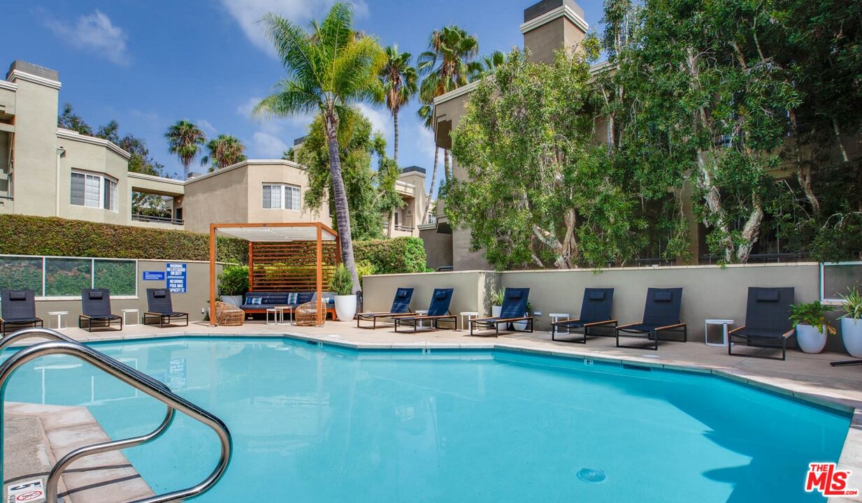 a view of a swimming pool with outdoor seating