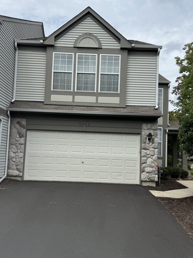 a front view of a house with a parking