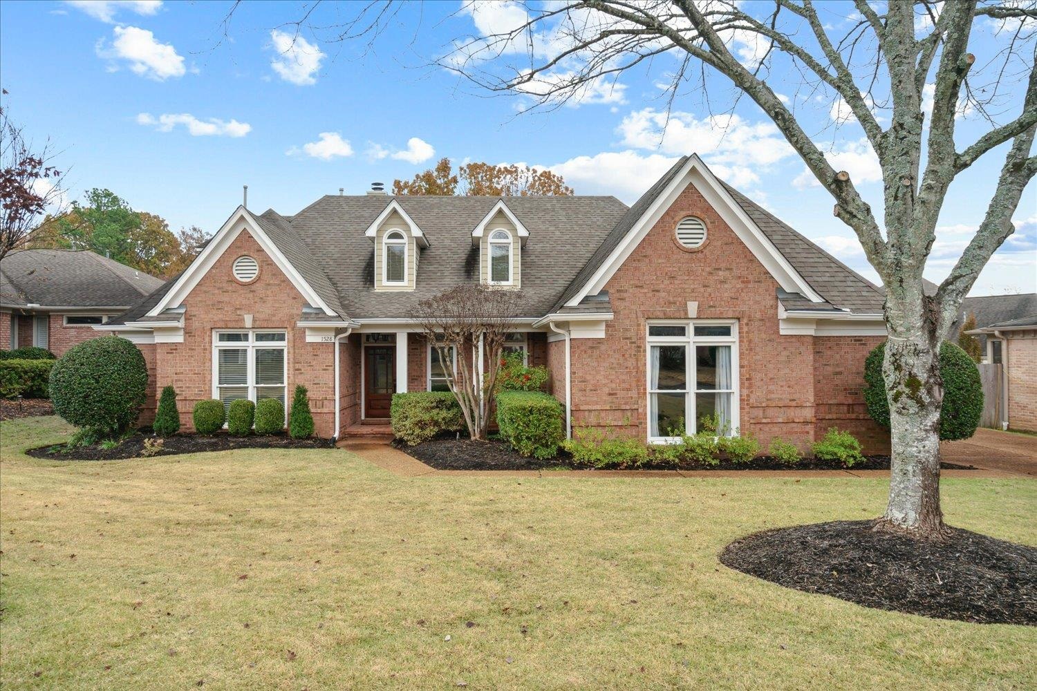 a front view of a house with a yard