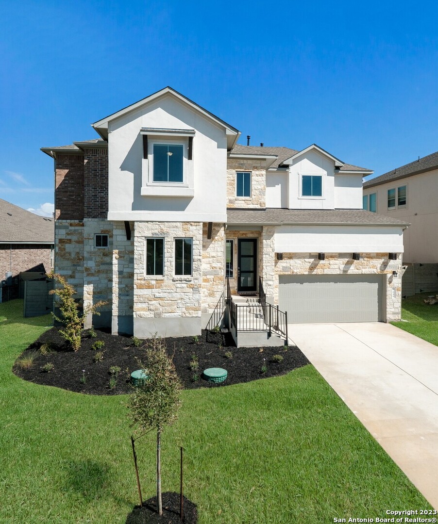 a front view of a house with a yard