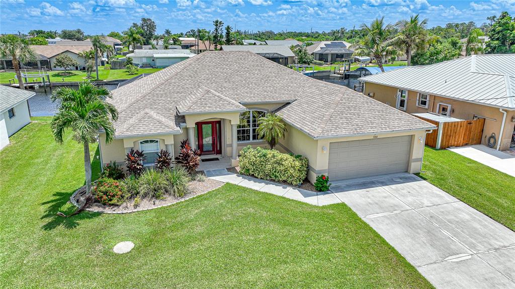 an aerial view of a house with yard and green space