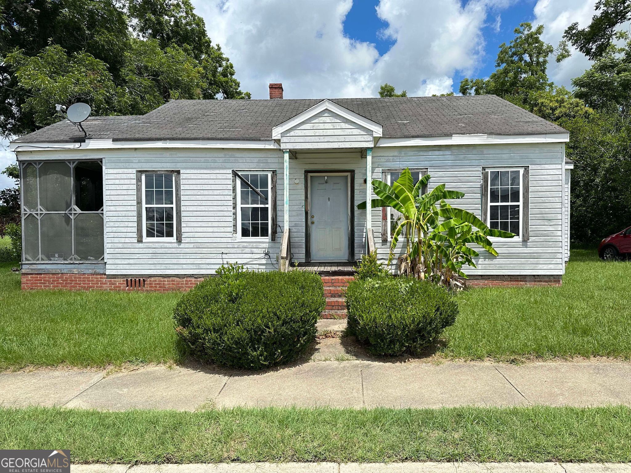 a front view of a house with garden