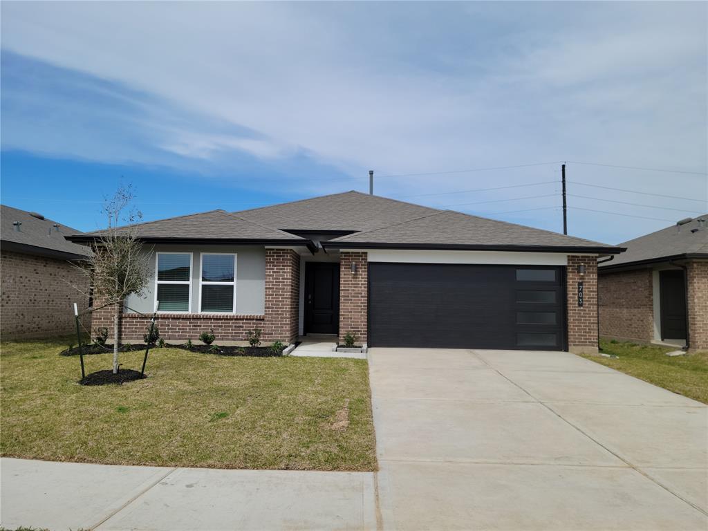 a front view of a house with yard and parking space