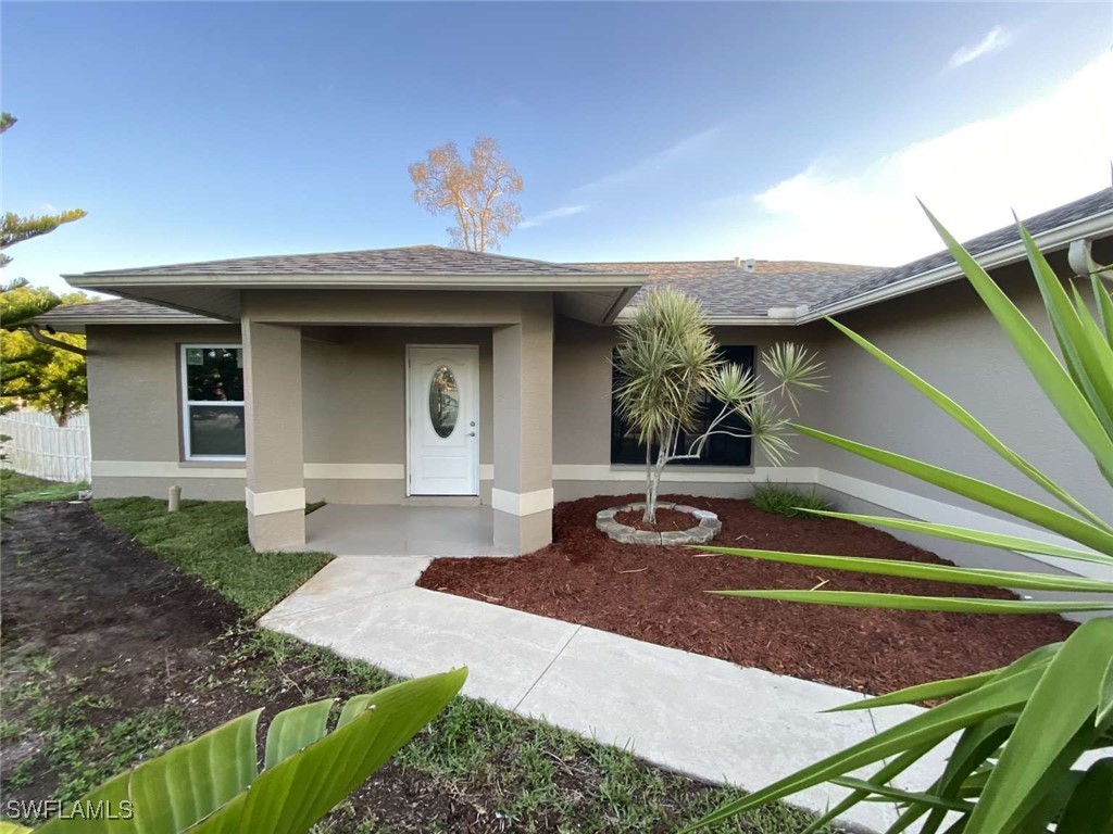 a front view of a house with garden