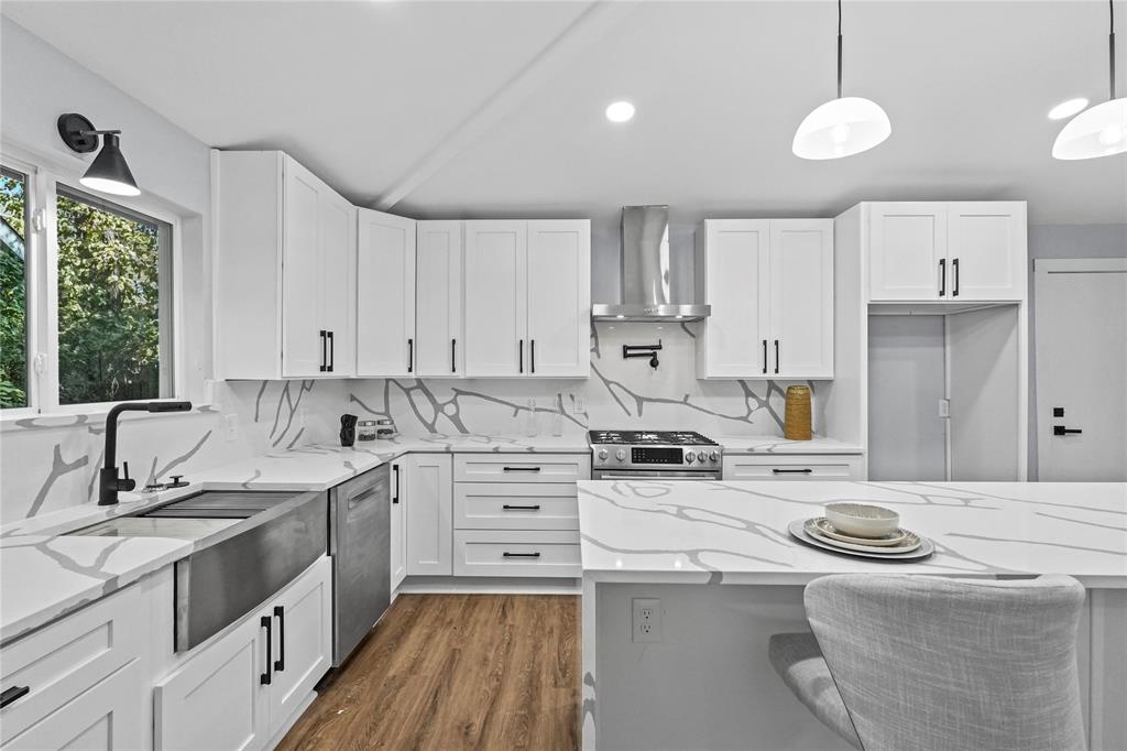 a kitchen with a sink stove and cabinets