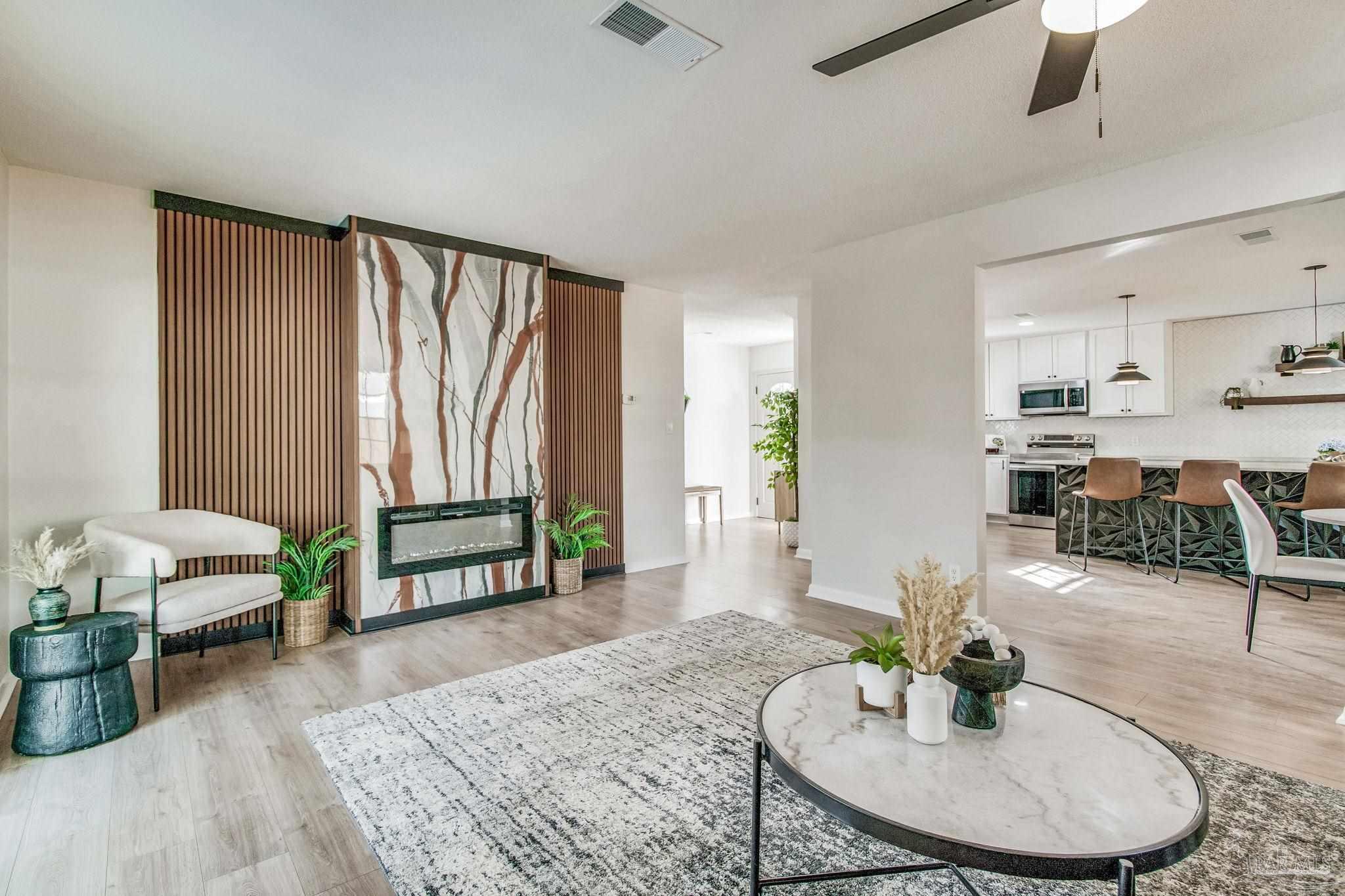 a living room with furniture and a wooden floor