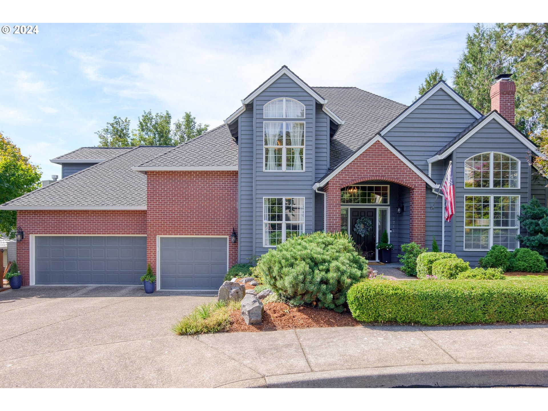 a front view of a house with a yard and garage