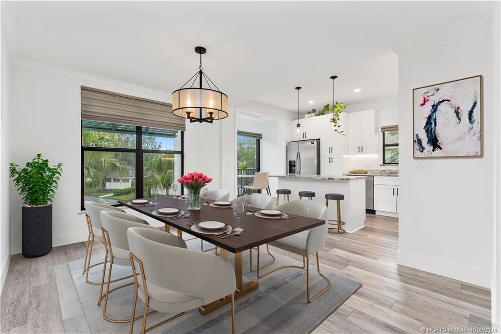 a dining room with wooden floor a chandelier a wooden table and chairs