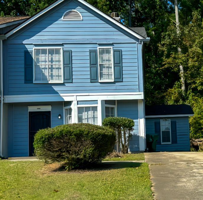 a front view of a house with a yard