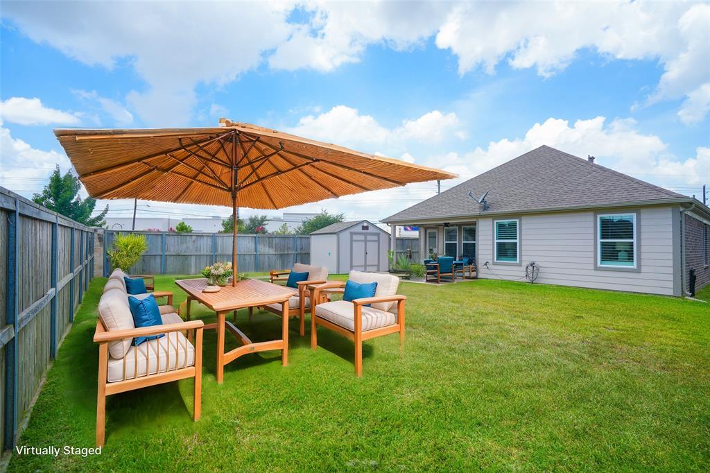 a patio with a table and chairs under an umbrella