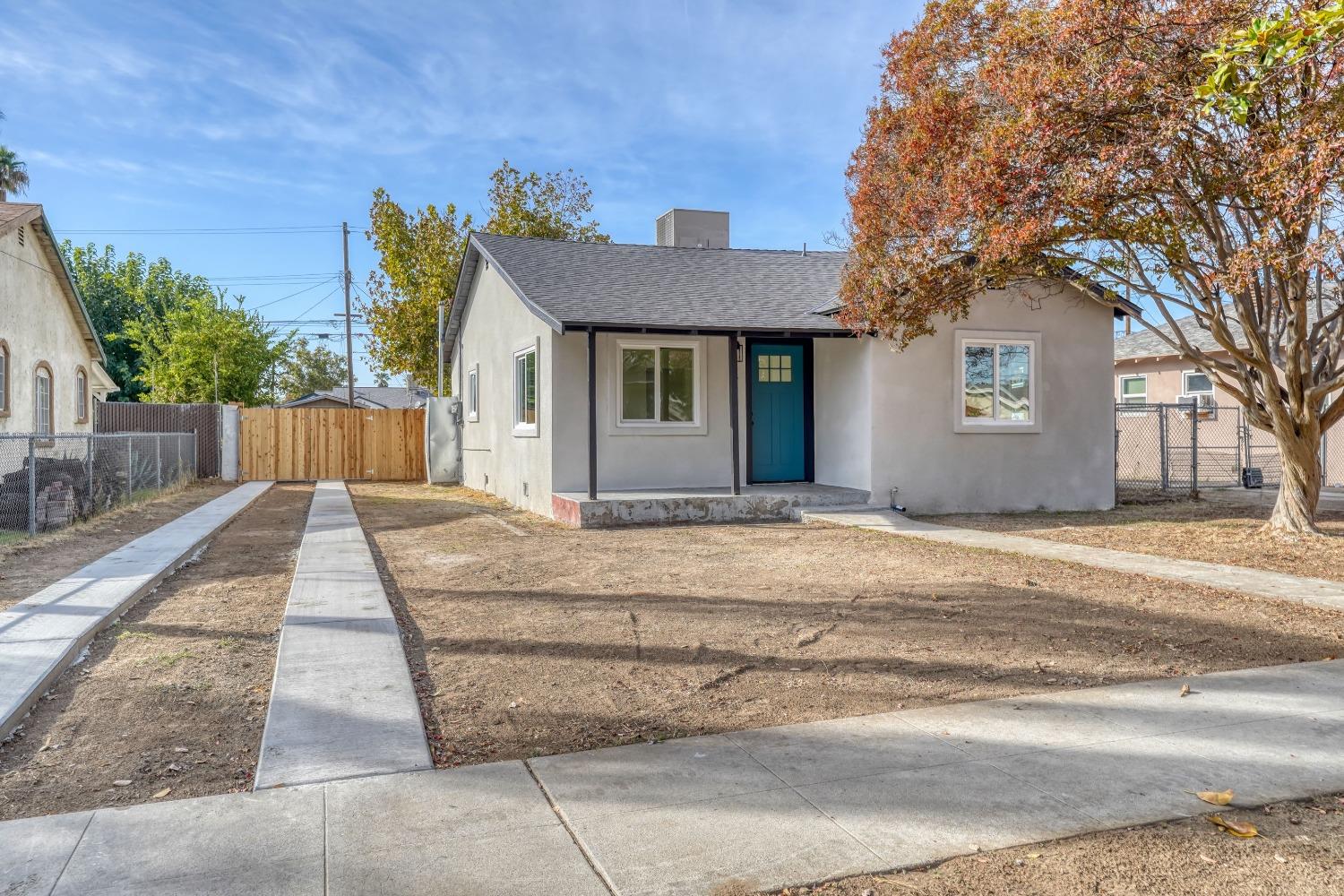 a front view of a house with a yard and a garage