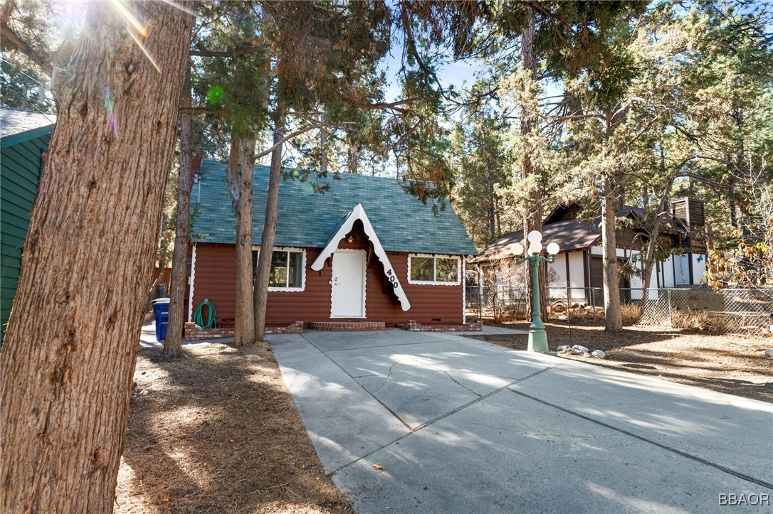 a view of a house with a tree in the background