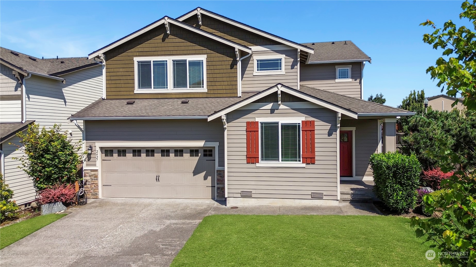 a front view of a house with a yard and garage