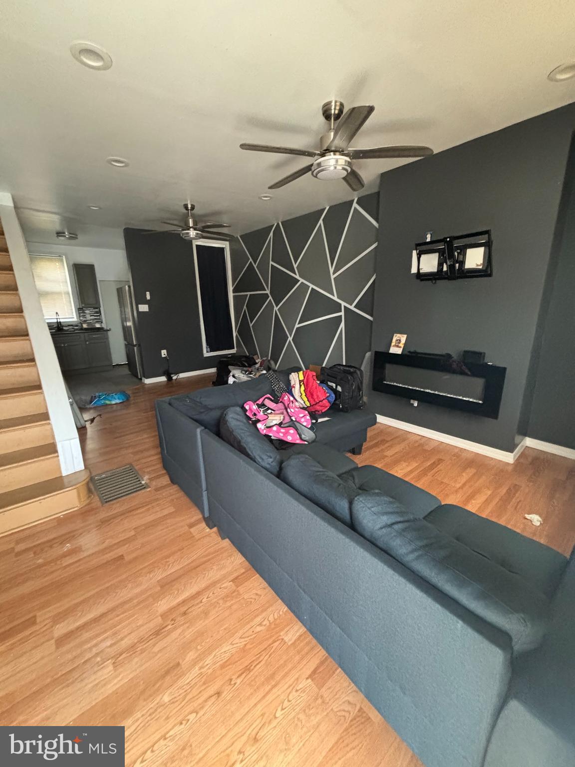 a living room with hard wood flooring