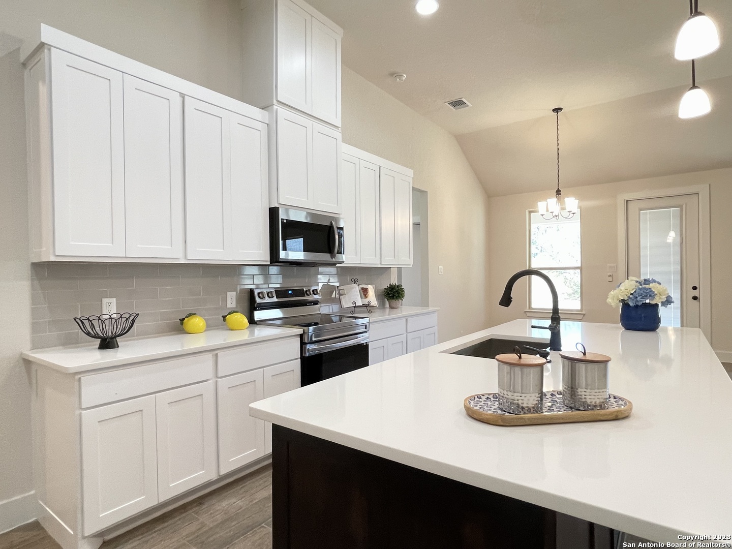 a kitchen with a sink cabinets and appliances