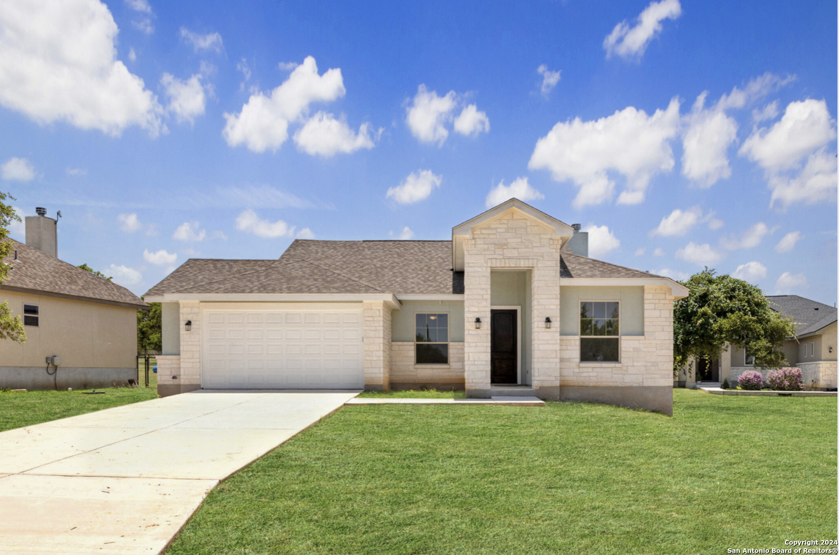 a front view of a house with a garden