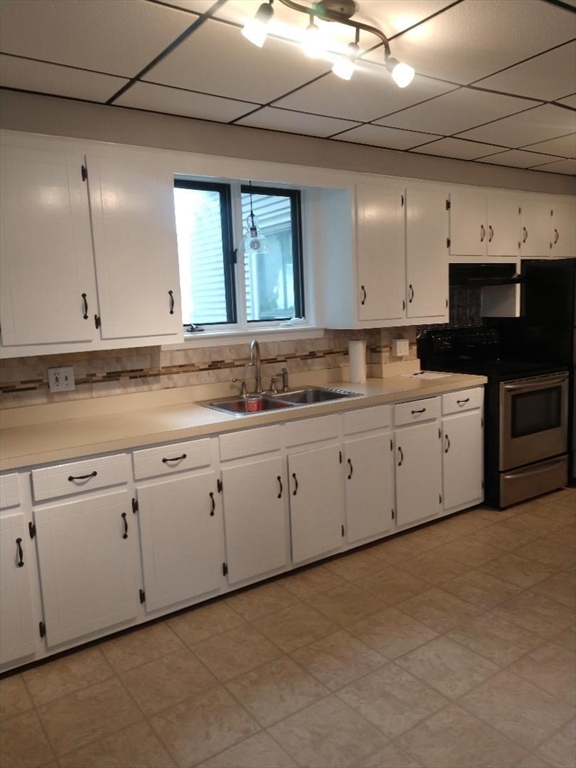 a kitchen with cabinets appliances a sink and a counter top