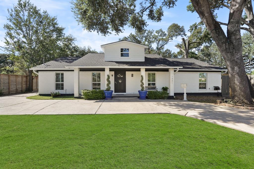 a front view of a house with a garden and yard