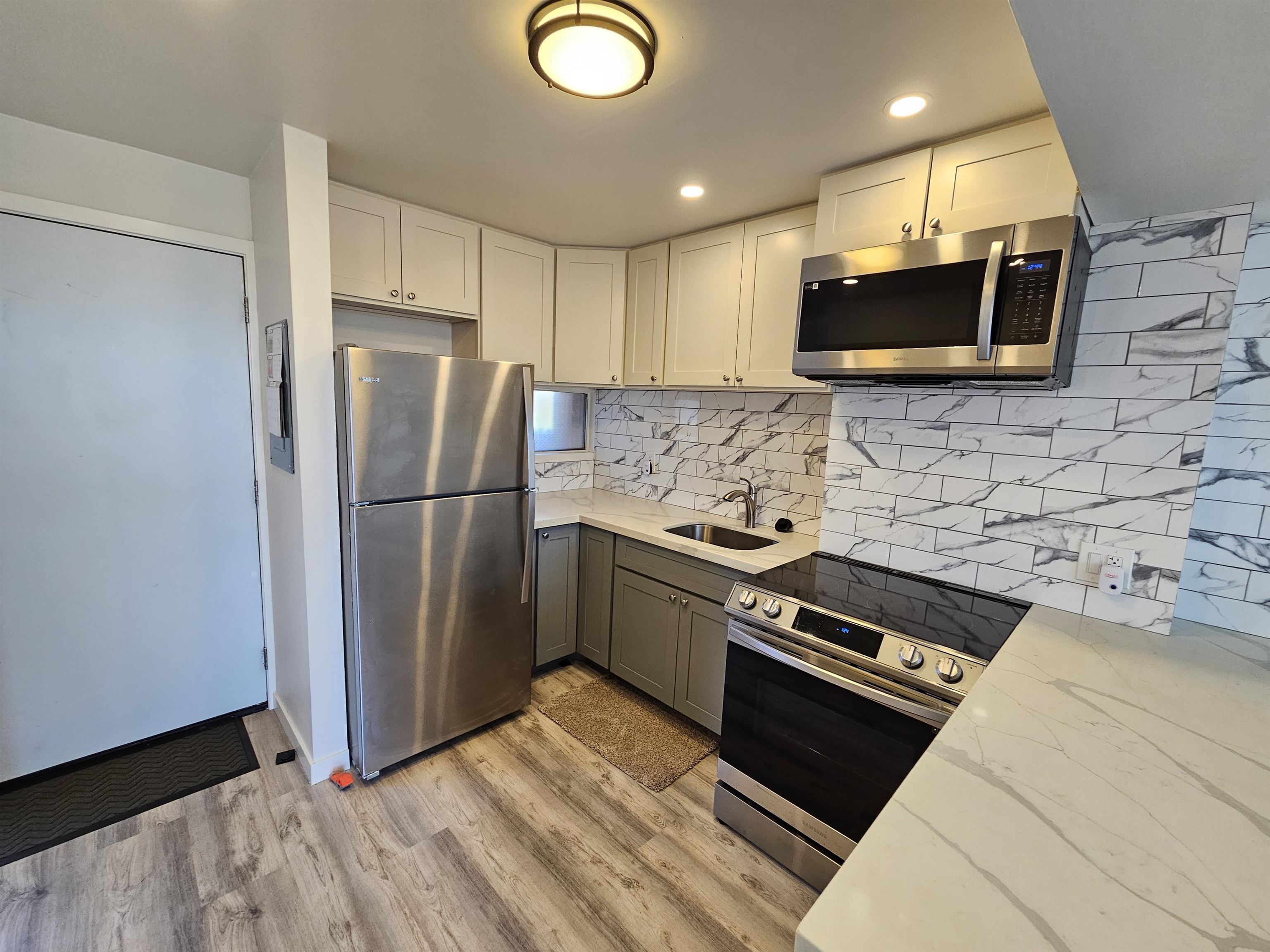 a kitchen with stainless steel appliances a refrigerator a stove a microwave and cabinets