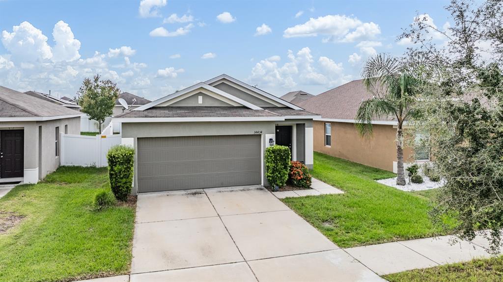 a front view of a house with a yard and garage