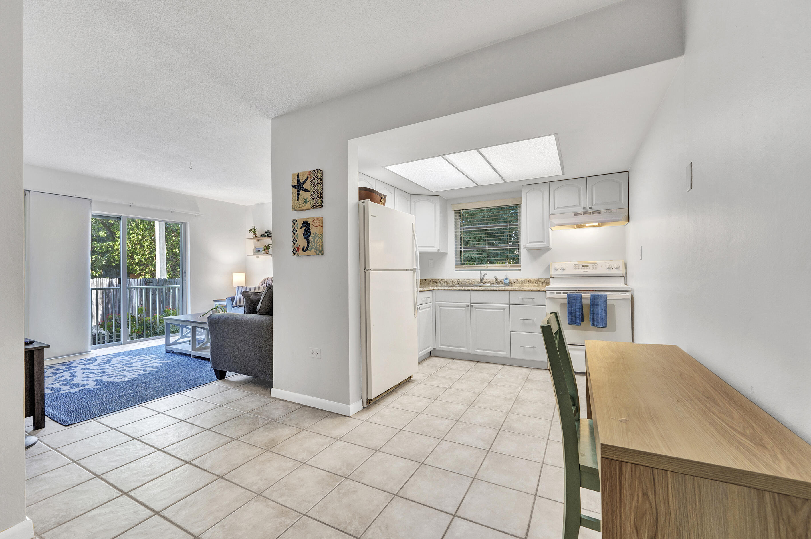 a kitchen with cabinets and refrigerator