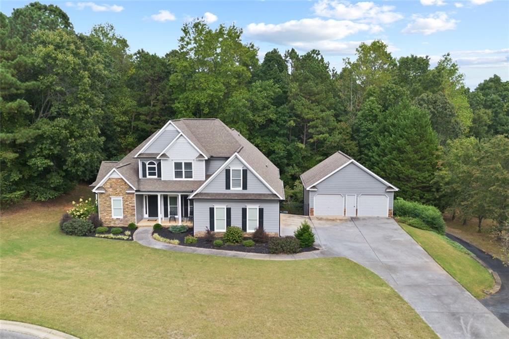 a front view of a house with yard and green space