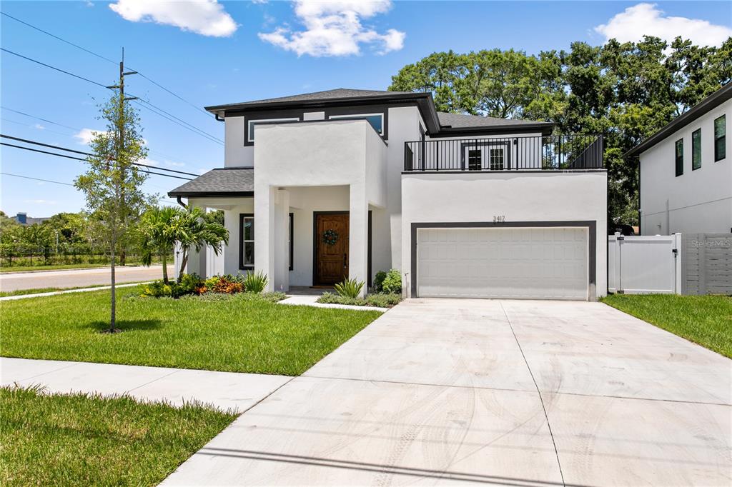 a front view of a house with a yard and garage