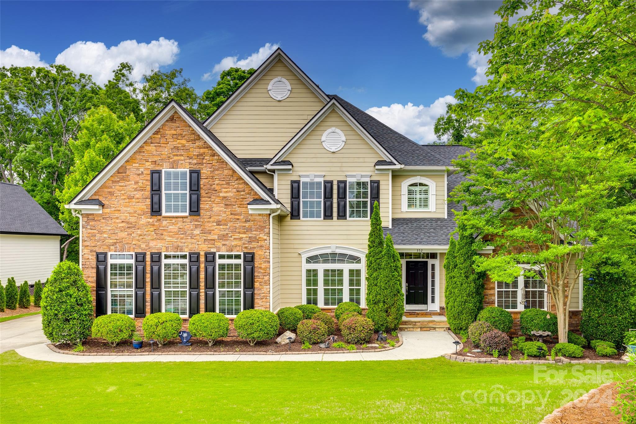 a front view of a house with garden