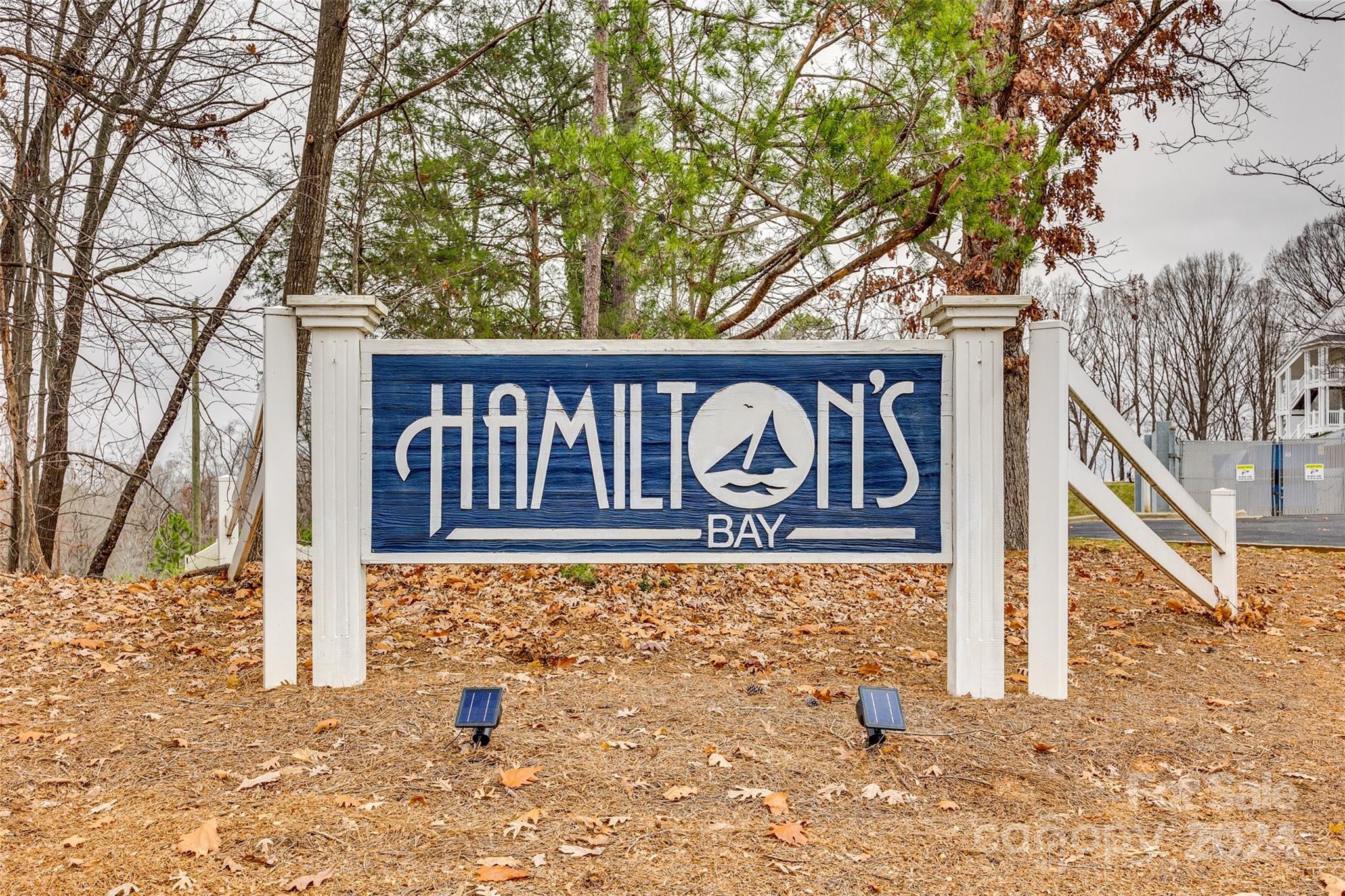 a street sign on a wall next to a road