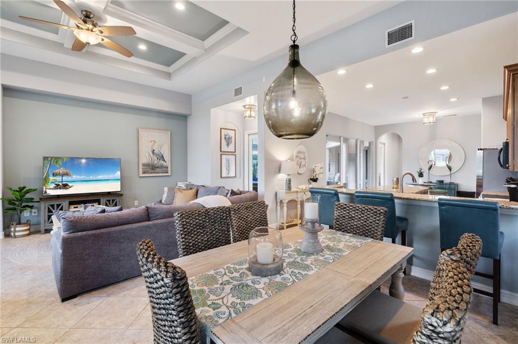 Dining room with ornamental molding, coffered ceiling, ceiling fan, beam ceiling, and plenty of natural light