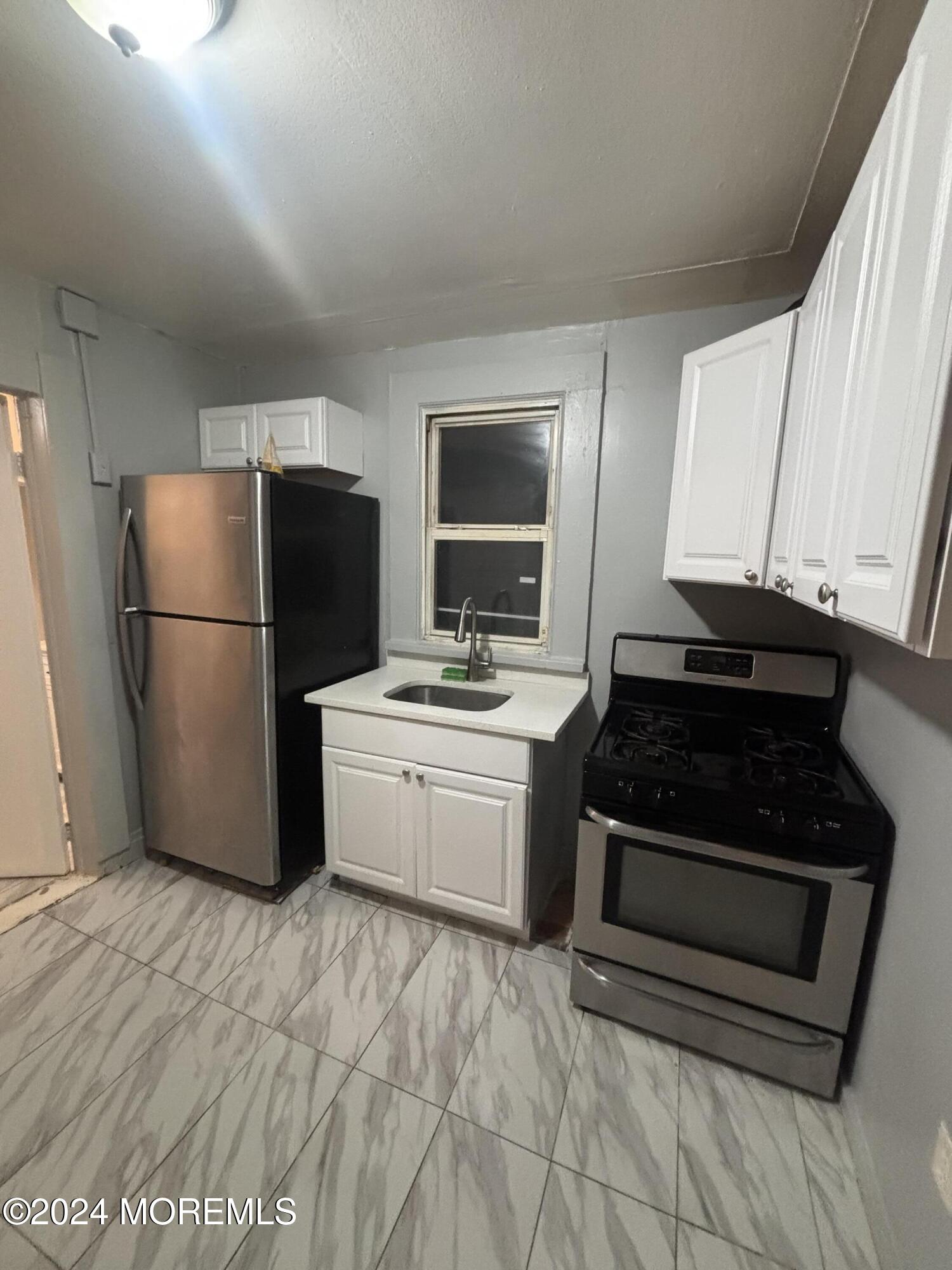 a kitchen with a refrigerator stove and a sink