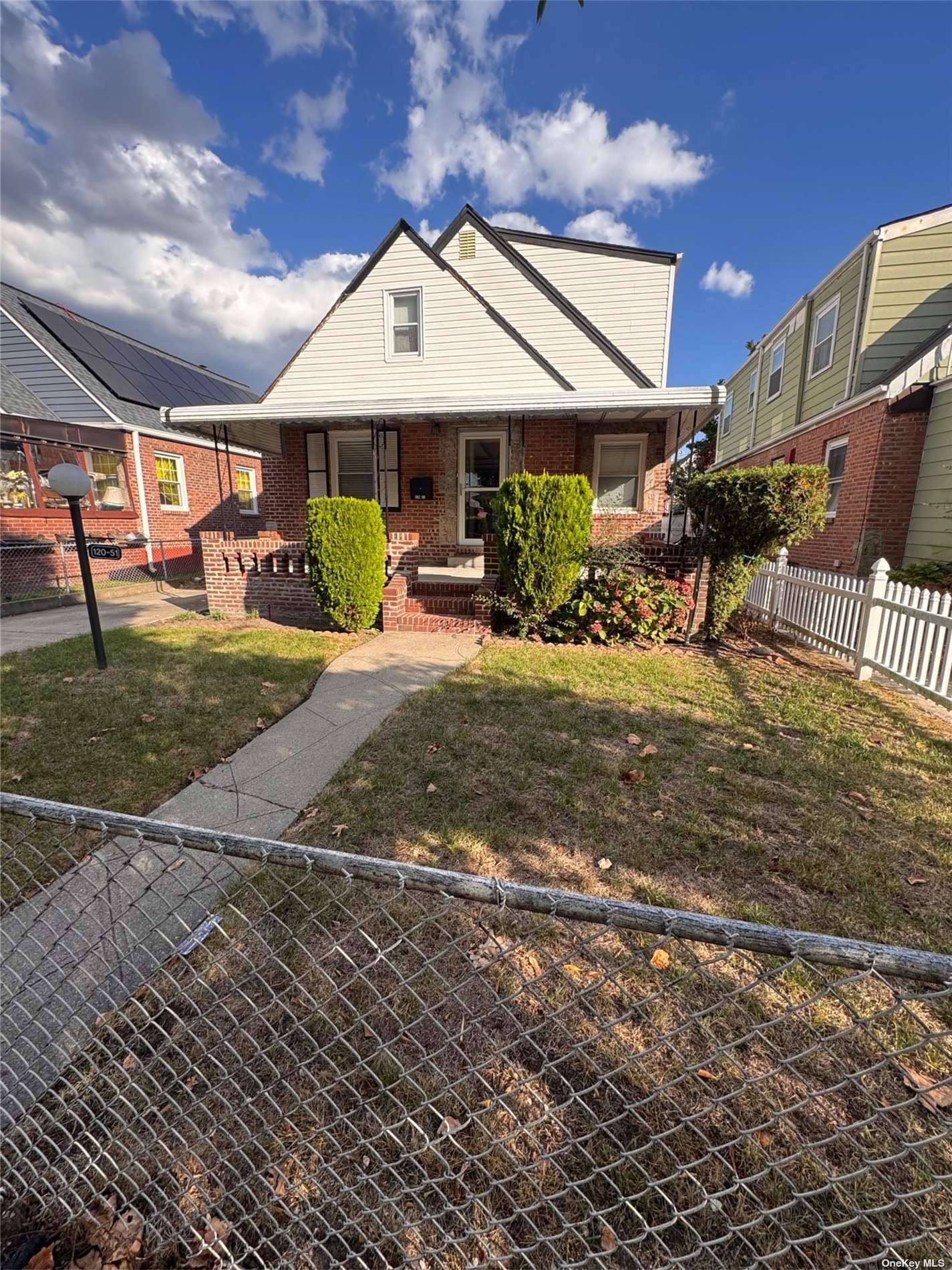 a view of a house with backyard porch and sitting area