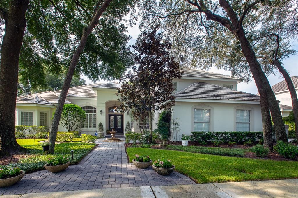 a front view of a house with yard and green space