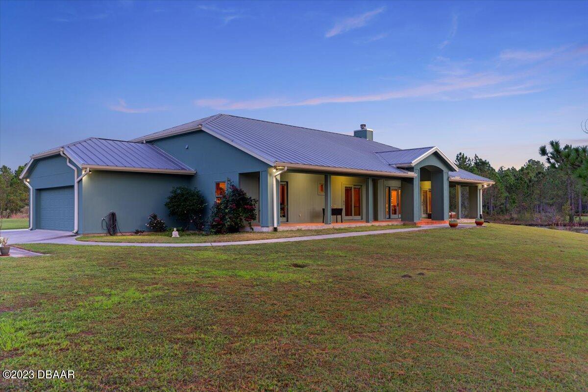 a front view of a house with a garden