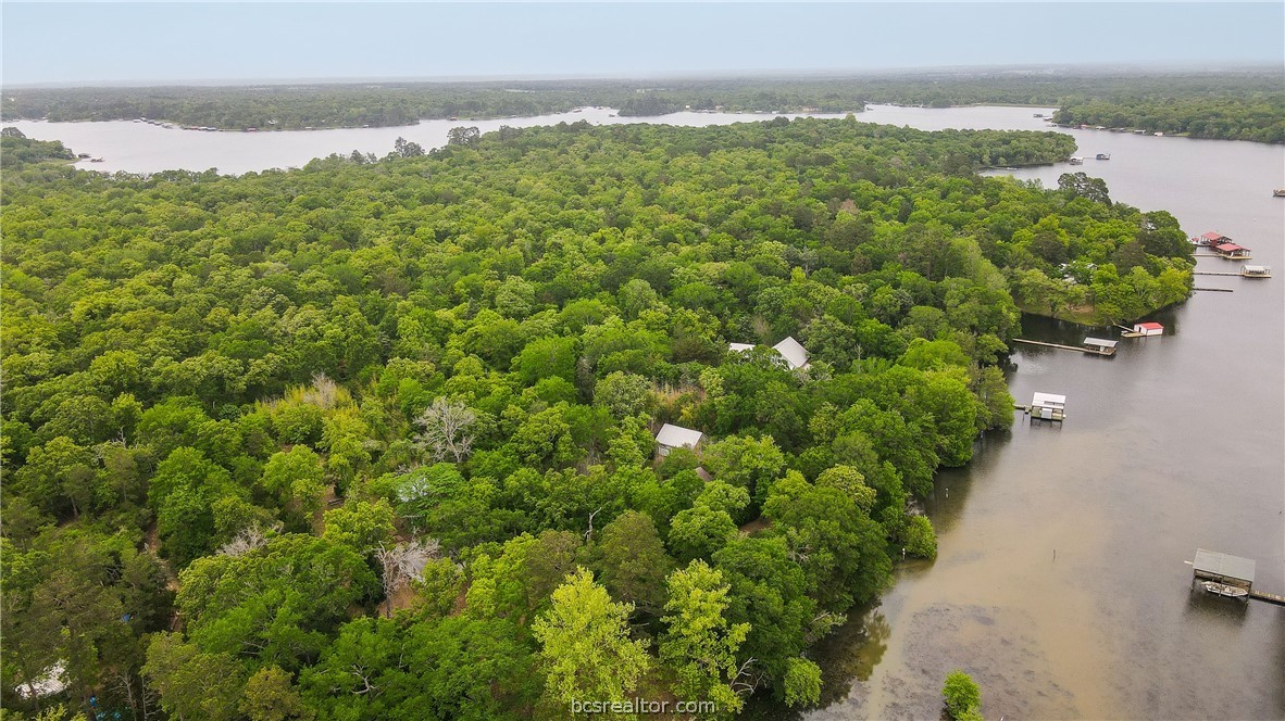 an aerial view of a houses with a yard